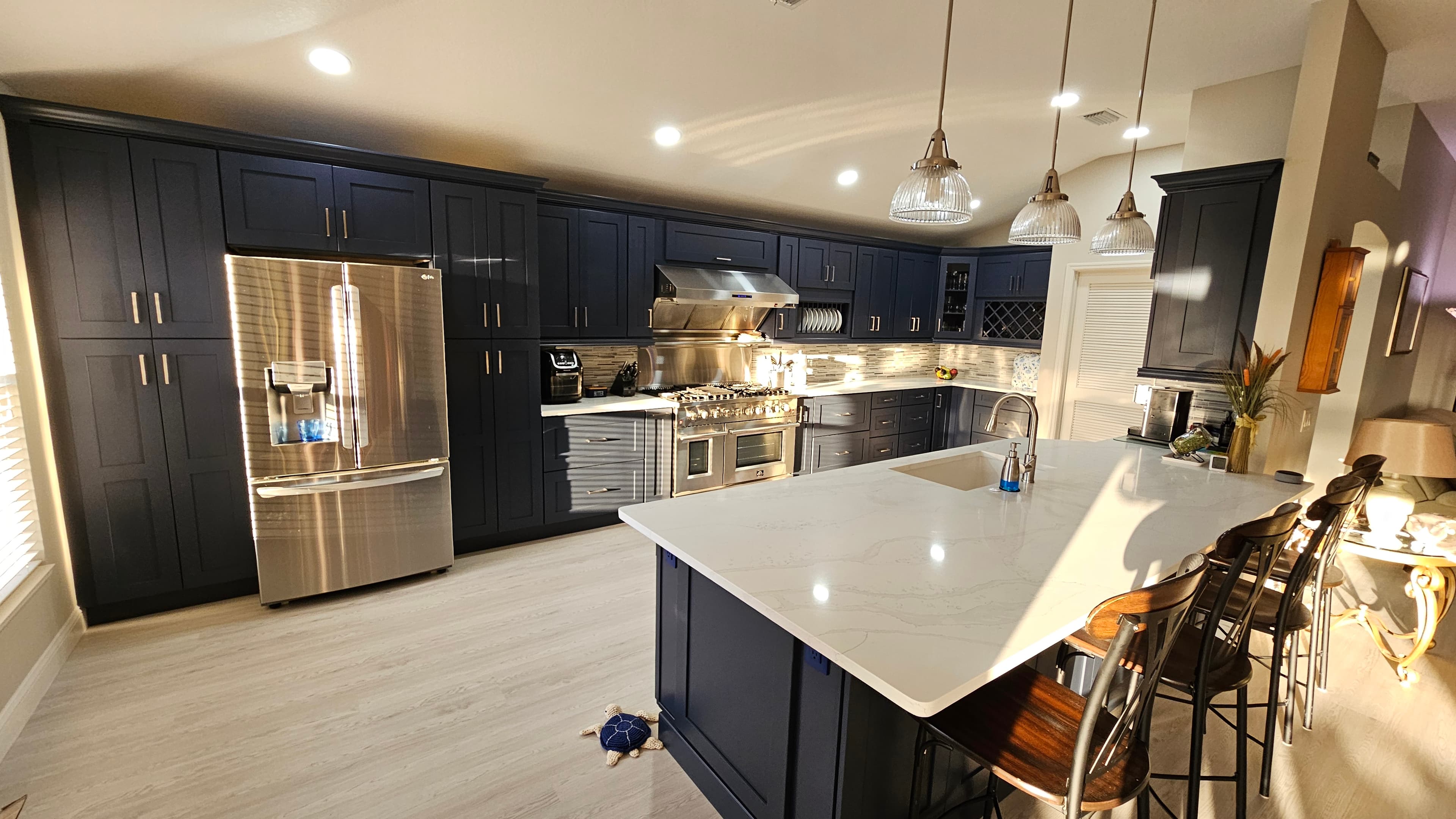 Glide-Lock kitchen - Navy Shaker with marble waterfall island and Wolf range